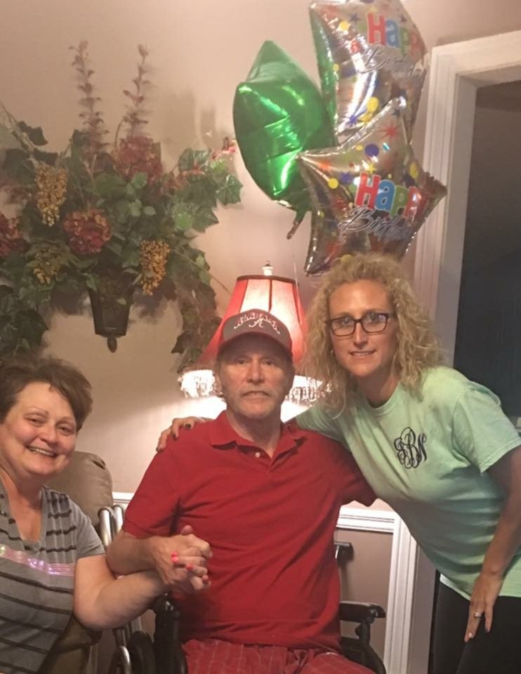 Jenn Board with her father on his last birthday, holding balloons, and her mother beside them.